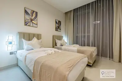 a hotel room with two beds and a window at 2 Bed Apt in District One Dubai - Lagoon Views in Dubai