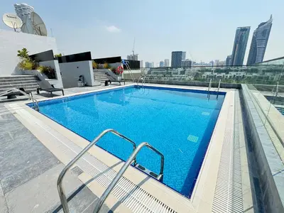 a large swimming pool on the roof of a building at luxury london style studio-loci residences in Dubai