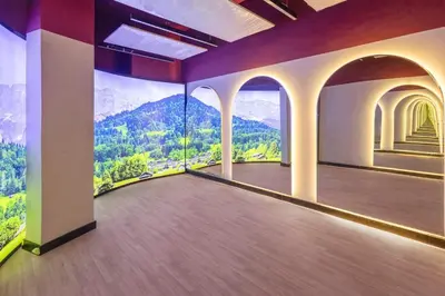 a room with a mountain view mural on the wall at luxury london style studio-loci residences in Dubai