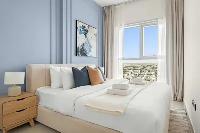a bedroom with a large white bed with a window at Silkhaus in Collective Tower Luxorious 2BDR in Dubai