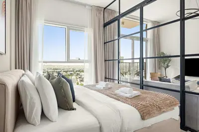 a bedroom with a large bed with a large window at Silkhaus in Collective Tower Luxorious 2BDR in Dubai