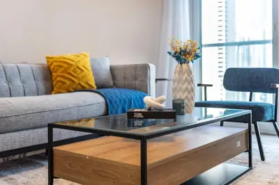 a living room with a couch and a glass coffee table at ShoresInn - Fantastic Marina Waterfront View in Dubai