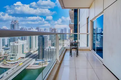 a balcony with a table and a view of the city at ShoresInn - Fantastic Marina Waterfront View in Dubai
