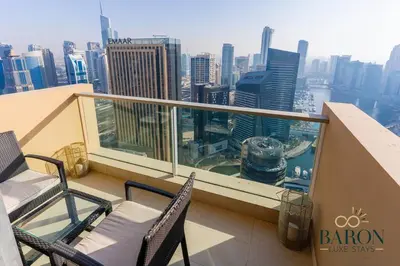 a balcony with two chairs and a view of the city at The Haven in Dubai