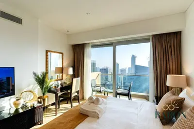 a hotel room with a bed and a view of the city at The Haven in Dubai