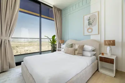 a bedroom with a bed and a large window at GuestReady - Glamorous stay at Binghatti Corner in Dubai