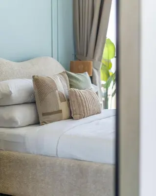 a pile of pillows sitting on top of a bed at GuestReady - Glamorous stay at Binghatti Corner in Dubai