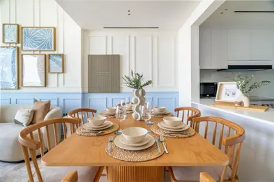 a dining room with a wooden table and chairs at GuestReady - Glamorous stay at Binghatti Corner in Dubai