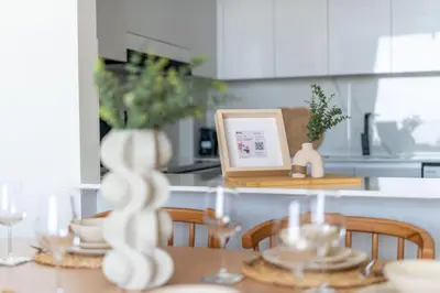 a dining room table with a picture and a dining room tableablish at GuestReady - Glamorous stay at Binghatti Corner in Dubai