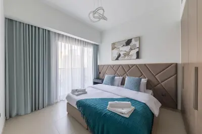 a bedroom with a large bed and a window at Spacious 3BR plus maids Burj Khalifa View in Dubai