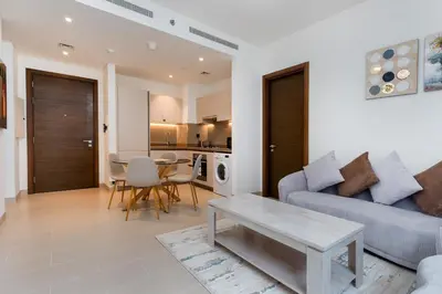 a living room with a couch and a table at Ahlan HH - Luxury 2BR in Sobha Creek Vistas in Dubai