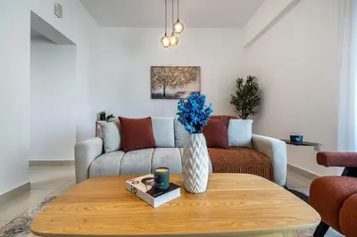 a living room with a table and a couch at ShoresInn - Heavenly Escape with Marina View in Dubai