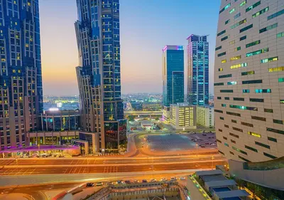 a city skyline with tall buildings and street lights at NiceVisit Merano 1BD Business Bay in Dubai