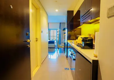 a kitchen with yellow walls and a hallway with a counter at NiceVisit Majestine Stuido Business bay in Dubai