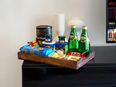 a tray with drinks and snacks on a table at Burj Khalifa View Luxe 2BR, 5 Mins walk to Dubai Mall in Dubai