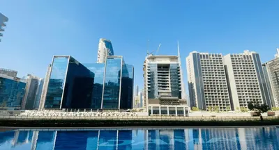 a group of tall buildings in a city at AWS Holiday Homes - Lux Gateaway near Dubai Mall in Dubai