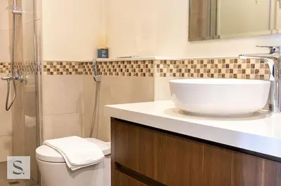 a bathroom with a white sink and a toilet at AWS Holiday Homes - Lux Gateaway near Dubai Mall in Dubai
