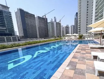 a swimming pool in a city with tall buildings at AWS Holiday Homes - Lux Gateaway near Dubai Mall in Dubai