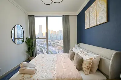 a bedroom with a large bed and a large window at CH Skyline Retreat - Cozy 1BR Apt With Burj Khalifa and Fountain Views in Dubai