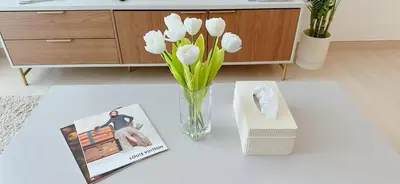a table with a vase of flowers and a book at Stylish 1br Apartment Jvc Pool Parking in Dubai