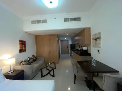 a living room with a couch and a table at Studio Apartment in Dubai in Dubai