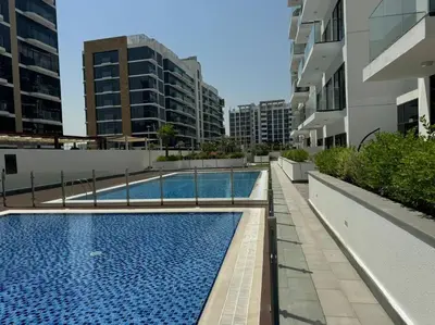 a swimming pool on the side of a building at Stunning Studio in Meydan Azizi 42 in Dubai