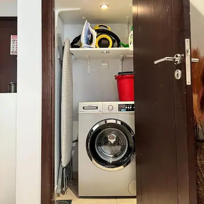 a washer and dryer in a small room at Downtown Gem, Fountain View! in Dubai
