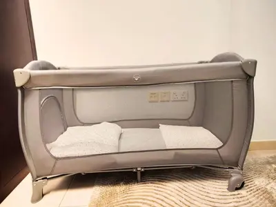 a baby crib with its door open in a room at Downtown Gem, Fountain View! in Dubai