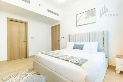 a white bedroom with a large white bed in it at Chic 2BR with Partial Burj Khalifa View in Dubai