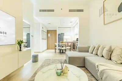 a living room with a couch and a table at Chic 2BR with Partial Burj Khalifa View in Dubai