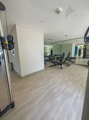 an empty gym with chairs and a white wall at Chic 2BR with Partial Burj Khalifa View in Dubai