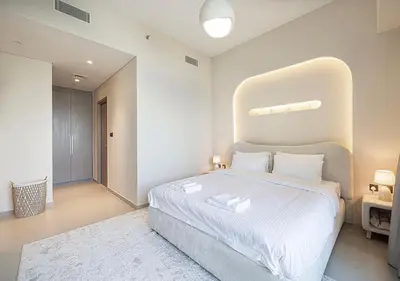 a bedroom with a large bed with a large headboard at Luxury Apartment with Full Burj Khalifa and Downtown Views in Dubai