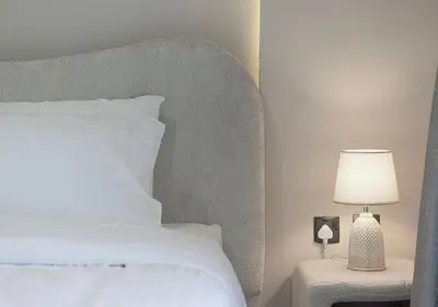 a bedroom with a white bed and a lamp at Luxury Apartment with Full Burj Khalifa and Downtown Views in Dubai