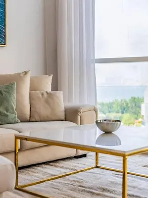 a living room with a couch and a coffee table at Seaside Elegance-1BR-Al Bateen-Private Beach Access in Dubai