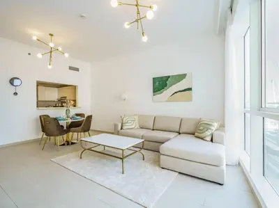 a living room with a couch and a table at Seaside Elegance-1BR-Al Bateen-Private Beach Access in Dubai