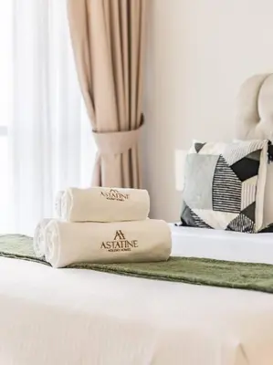 a pile of towels sitting on a bed at Seaside Elegance-1BR-Al Bateen-Private Beach Access in Dubai