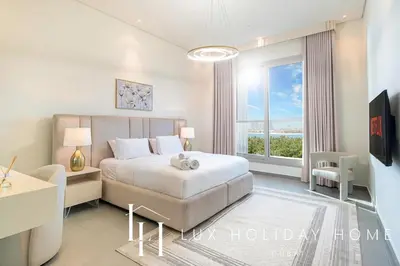 a white bedroom with a bed and a large window at LUX The Dream Palm Atlantis Sea View Suite in Dubai