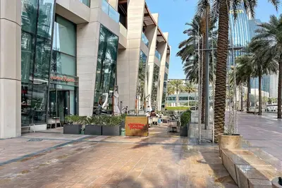 a shopping mall with palm trees in front of a building at FIRST CLASS 2BR Stunning City Views in Dubai