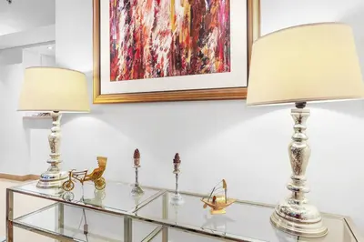 two lamps sitting on top of a glass table at FIRST CLASS 2BR Stunning City Views in Dubai