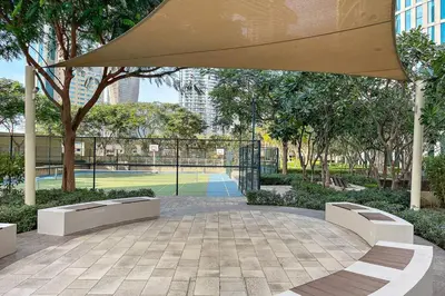 a patio with two benches and a large umbrella at FIRST CLASS 2BR Stunning City Views in Dubai