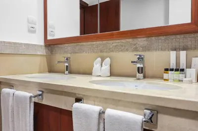 a bathroom with two sinks and two towels at FIRST CLASS 2BR Stunning City Views in Dubai