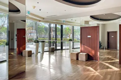 a lobby with a hallway with wooden doors and windows at FIRST CLASS 2BR Stunning City Views in Dubai