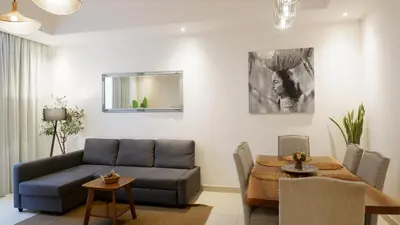 a living room with a couch and a table at Bliss at the Fields, 5BR Villa with Garden in Meydan in Dubai