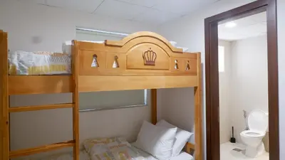 a bunk bed in a small room with a toilet at Bliss at the Fields, 5BR Villa with Garden in Meydan in Dubai
