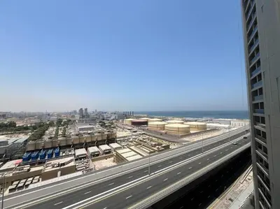 a view of a highway with a city and the ocean at Studio in Studio One Marina in Dubai