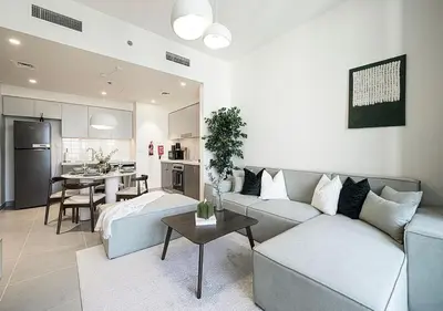 a living room with a couch and a table at Kinfolk Homes - 5-Star Family Stay, 8 Minutes Walk to Dubai Mall & Burj Khalifa in Dubai