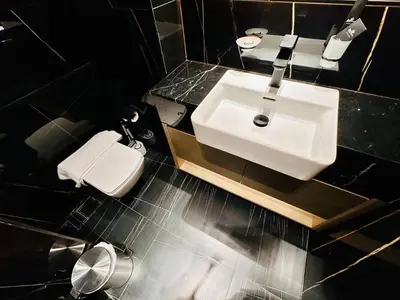 a bathroom with a white sink and a toilet at Modern 1br In Jvc Fully Furnished & Balcony in Dubai