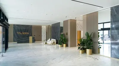 a lobby with potted plants in a building at Modern 1br In Jvc Fully Furnished & Balcony in Dubai