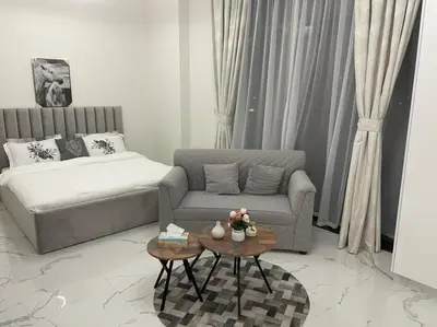 a living room with a couch and a coffee table at Luxury & Comfort in Majan A Dubai Delight in Dubai