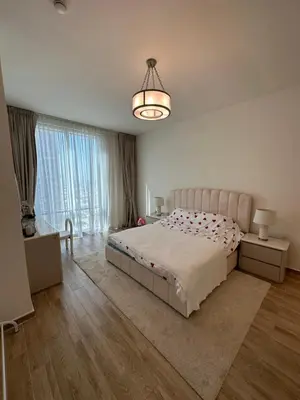 a bedroom with a large bed and a large window at 2 Bedroom in Noora Tower, Fully furnished, Sea View in Dubai